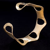 Side view of hammered brass cuff bracelet with ovals from Capulin Creations