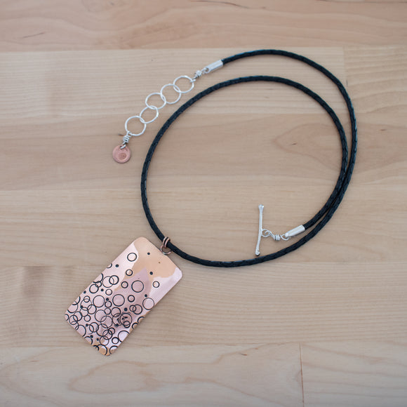 Full View of the Large Pendant Necklace in Copper from the Bubbles Collection