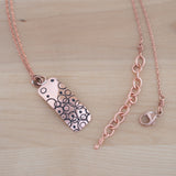 Detailed View of the Small Pendant Necklace in Copper from the Bubble Collection