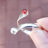 Hand of woman holding the Carnelian and Sterling Silver Adjustable Ring with One Stone and One Granule