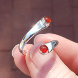 Hand of woman holding the Carnelian and Sterling Silver Adjustable Ring with Two Stones