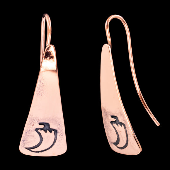 Front and side views of triangle-shaped copper dangle earrings stamped with chile peppers from Capulin Creations