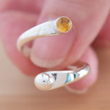 Hand of woman holding the Citrine and Sterling Silver Adjustable Ring with One Stone and One Granule