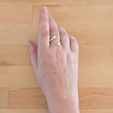 Hand of woman wearing the Citrine and Sterling Silver Adjustable Ring with One Stone and One Granule