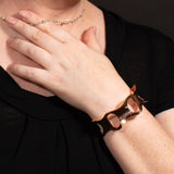 Woman wearing hammered copper cuff bracelet with ovals from Capulin Creations