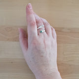 Hand Wearing the Emerald and Sterling Silver Adjustable Ring with One Stone and One Granule