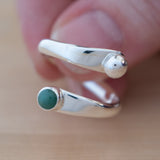 Hand Holding the Emerald and Sterling Silver Adjustable Ring with One Stone and One Granule