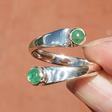Hand Holding the Emerald and Sterling Silver Adjustable Ring with Two Stones
