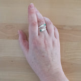 Hand Wearing the Emerald and Sterling Silver Adjustable Ring with Two Stones