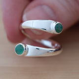 Hand Holding the Emerald and Sterling Silver Adjustable Ring with Two Stones