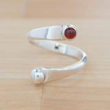 Front view of the Garnet and Sterling Silver Adjustable Ring with One Stone and One Granule