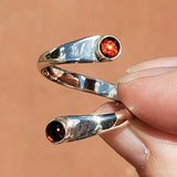 Hand of woman holding the Garnet and Sterling Silver Adjustable Ring with Two Stones
