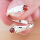 Hand of woman holding the Garnet and Sterling Silver Adjustable Ring with Two Stones