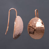 Front and side views of hammered dangle earrings in copper