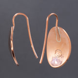 Back and side views of hammered dangle earrings in copper