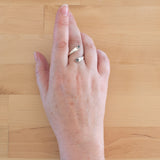 Hand of woman wearing the Hematite and Sterling Silver Adjustable Ring with Two Stones
