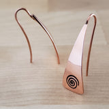 Front and Side Views of Triangle-Shaped Dangle Earrings in Copper Stamped with Large Spirals
