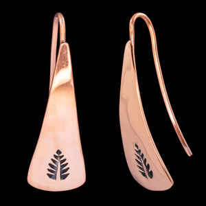 Front and side views of triangle-shaped copper dangle earrings stamped with leaves from Capulin Creations