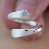 Hand of Woman Holding the Moonstone and Sterling Silver Adjustable Ring with One Stone