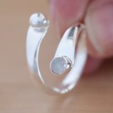 Woman's hand holding the Moonstone and Sterling Silver Adjustable Ring with One Stone and One Granule