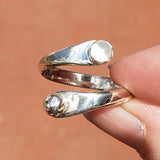 Woman's hand holding the Moonstone and Sterling Silver Adjustable Ring with One Stone and One Granule