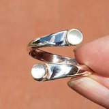 Hand of woman holding the Moonstone and Sterling Silver Adjustable Ring with Two Stones