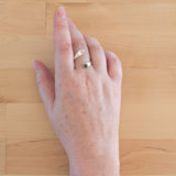 Hand of woman wearing the Nephrite Jade and Sterling Silver Adjustable Ring with One Stone and One Granule