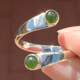 Hand of woman holding the Nephrite Jade and Sterling Silver Adjustable Ring with Two Stones