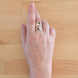 Hand of woman wearing the Nephrite Jade and Sterling Silver Adjustable Ring with Two Stones