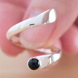 Hand of woman holding the Onyx and Sterling Silver Adjustable Ring with One Stone