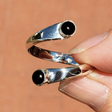 Hand of woman holding the Onyx and Sterling Silver Adjustable Ring with Two Stones