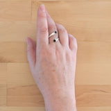 Hand of woman wearing the Onyx and Sterling Silver Adjustable Ring with Two Stones