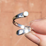 Hand of woman holding the Opal and Sterling Silver Adjustable Ring with One Stone
