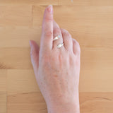 Hand of woman wearing the Opal and Sterling Silver Adjustable Ring with One Stone