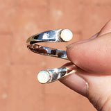 Hand of woman holding the Opal and Sterling Silver Adjustable Ring with Two Stones