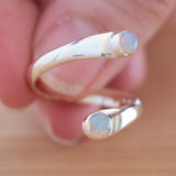 Hand of woman holding the Opal and Sterling Silver Adjustable Ring with Two Stones