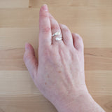Hand of Woman Wearing Pearl and Sterling Silver Adjustable Ring with One Stone