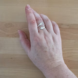 Hand of Woman Wearing Pearl and Sterling Silver Adjustable Ring with One Stone and One Granule