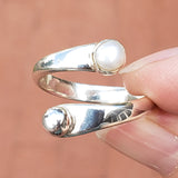 Hand of Woman Holding Pearl and Sterling Silver Adjustable Ring with One Stone and One Granule
