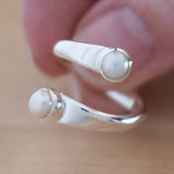 Hand of Woman Holding Pearl and Sterling Silver Adjustable Ring with Two Stones