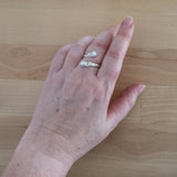 Hand of Woman Wearing Pearl and Sterling Silver Adjustable Ring with Two Stones