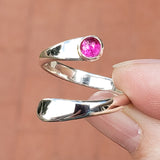 Hand of woman holding the Ruby and Sterling Silver Adjustable Ring with One Stone