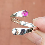 Hand of woman holding the Ruby and Sterling Silver Adjustable Ring with One Stone and One Granule