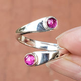 Hand of woman holding the Ruby and Sterling Silver Adjustable Ring with Two Stones