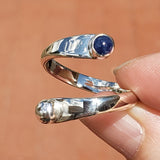 Hand of woman holding the Sapphire and Sterling Silver Adjustable Ring with One Stone and One Granule