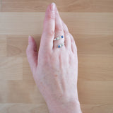 Hand of woman wearing the Sapphire and Sterling Silver Adjustable Ring with Two Stones