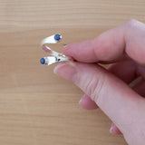 Hand of woman holding the Sapphire and Sterling Silver Adjustable Ring with Two Stones