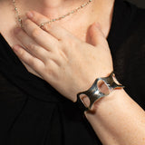 Woman wearing hammered silver cuff bracelet with ovals from Capulin Creations