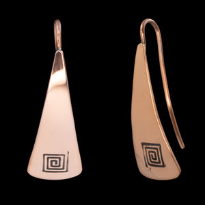 Front and side views of triangle-shaped copper earrings stamped with square spirals from Capulin Creations