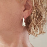 Woman wearing Triangle-Shaped Dangle Earrings in Sterling Silver stamped with stars